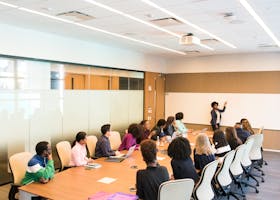 Professional team engaged in a collaborative boardroom meeting with a presentation in progress.